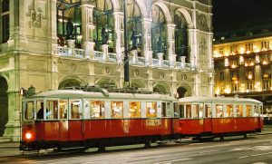 Particularly atmospheric: a classic tram from Rent a Bim in front of illuminated State Opera in Vienna in the evening