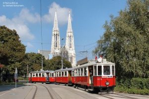 A magnificent three-car train from Rent a Bim in front of the Votive Church